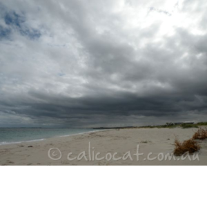 Photo of a beach with storm clouds